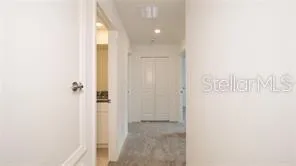 an empty room with a fan & a ceiling fan