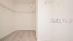 a bathroom with a granite countertop double vanity sink and a mirror