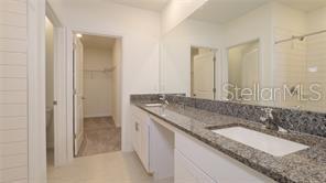 11142 Radiant Shr Loop San Antonio, FL 33576 - Photo 33 of 43 a bathroom with a granite countertop double vanity sink and a mirror