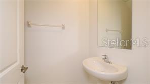 11142 Radiant Shr Loop San Antonio, FL 33576 - Photo 34 of 43 a bathroom with a sink and a mirror