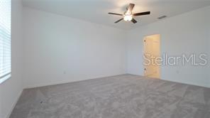 11142 Radiant Shr Loop San Antonio, FL 33576 - Photo 35 of 43 an empty room with windows and fan