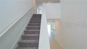 a view of staircase with white walls