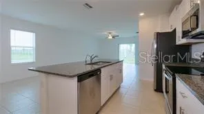a kitchen with granite countertop a sink and a stove
