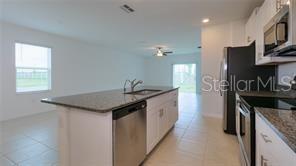 11142 Radiant Shr Loop San Antonio, FL 33576 - Photo 8 of 43 a kitchen with granite countertop a sink and a stove