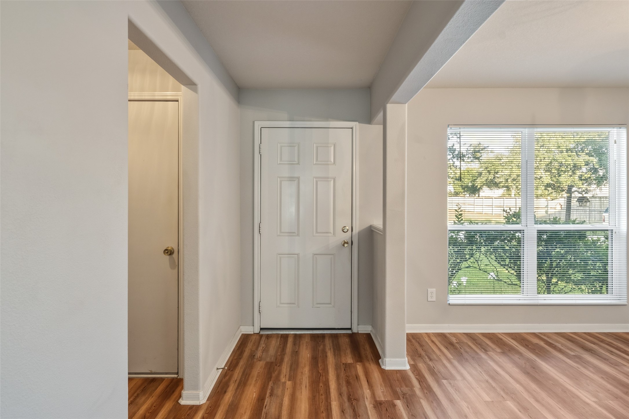 16820 Infield Court Conroe, TX 77385 - Photo 6 of 44 a view of a room with wooden floor a ceiling fan and a window