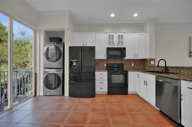 a kitchen with a refrigerator and a stove top oven