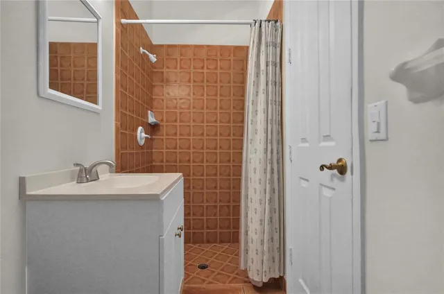 a bathroom with a sink a mirror and shower