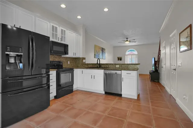 a kitchen with stainless steel appliances a refrigerator sink and cabinets