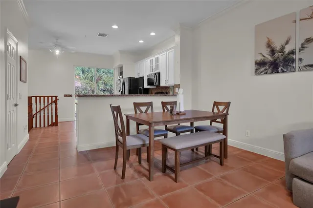 a dining room with furniture and a kitchen view