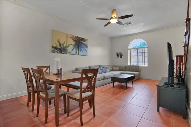 a view of a dining room with furniture and a chandelier