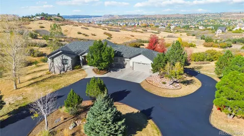 an aerial view of a house with yard swimming pool and lake view