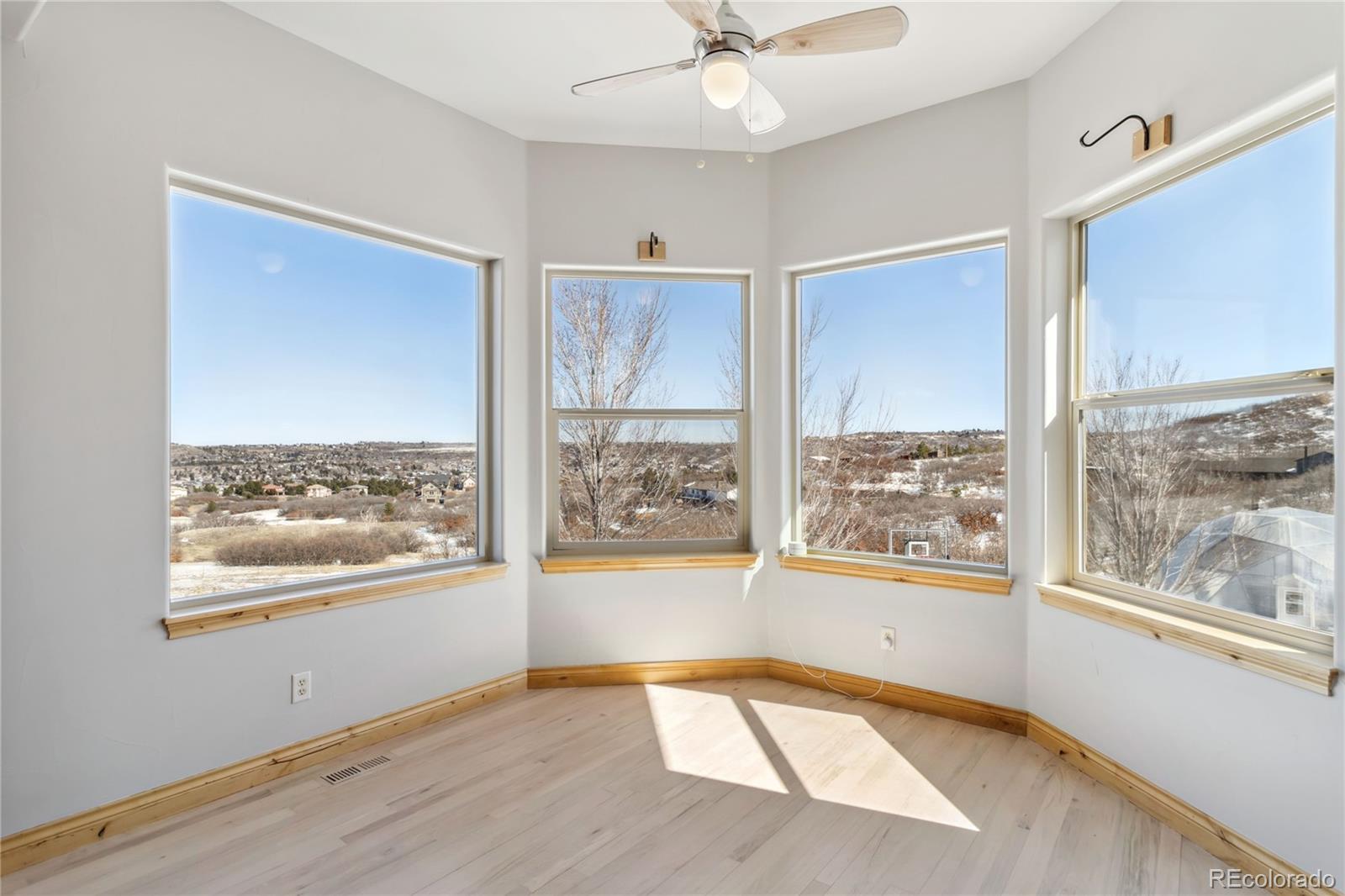 1967 Haystack Road Castle Rock, CO 80104 - Photo 14 of 50 a view of an empty room with a window and wooden floor