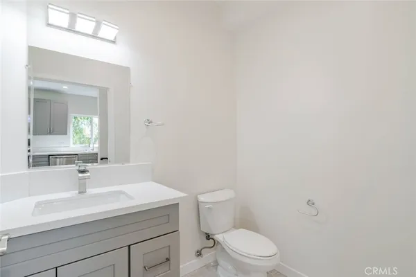 a bathroom with a sink a toilet and mirror