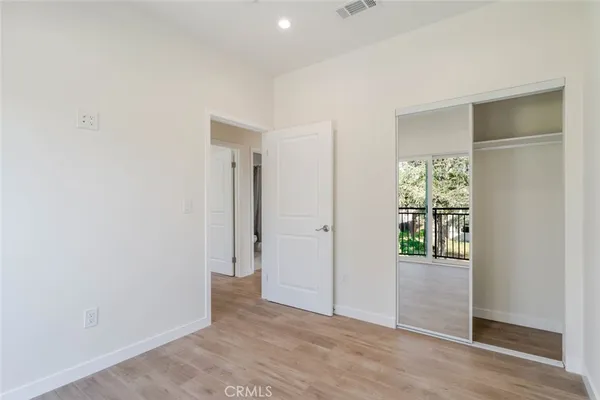 an empty room with windows and closet