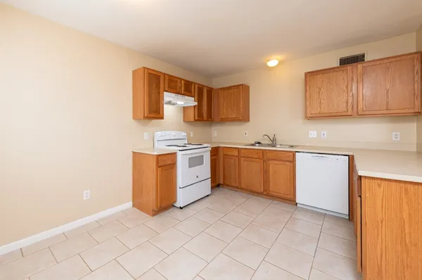 a kitchen with a stove top oven sink and cabinets