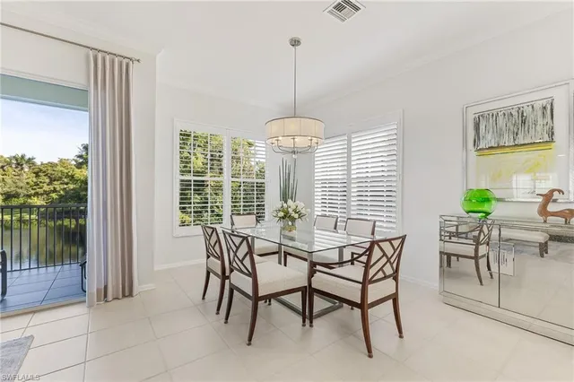 a living room with furniture and floor to ceiling windows