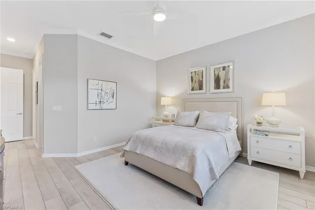 a bedroom with a bed and a couch next to a window