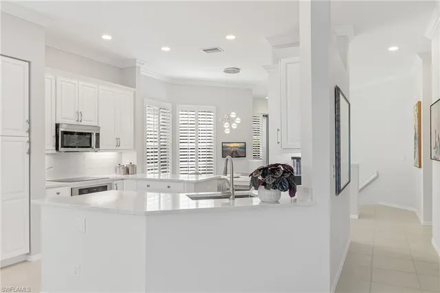 a kitchen with stainless steel appliances a sink and a refrigerator