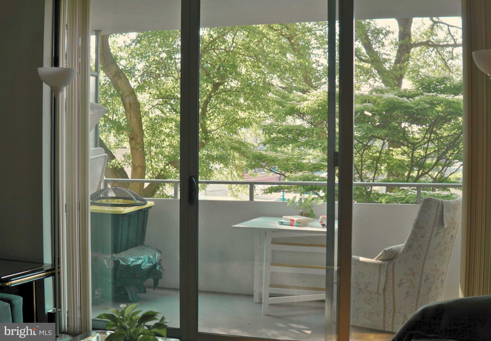 5101 River Road, Unit 405 Bethesda, MD 20816 - Photo 7 of 20 a view of a glass door and a yard