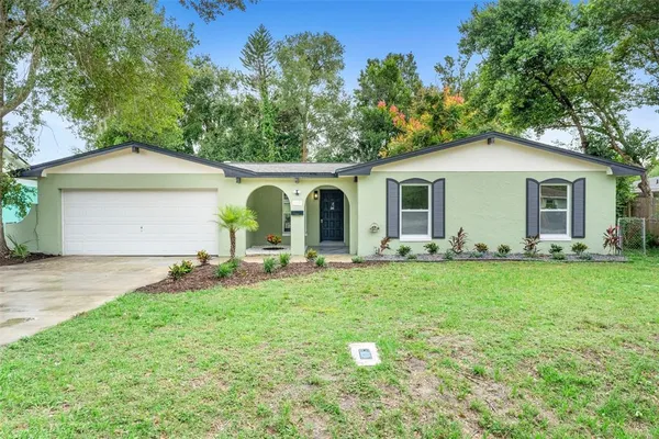 a front view of house with yard and green space