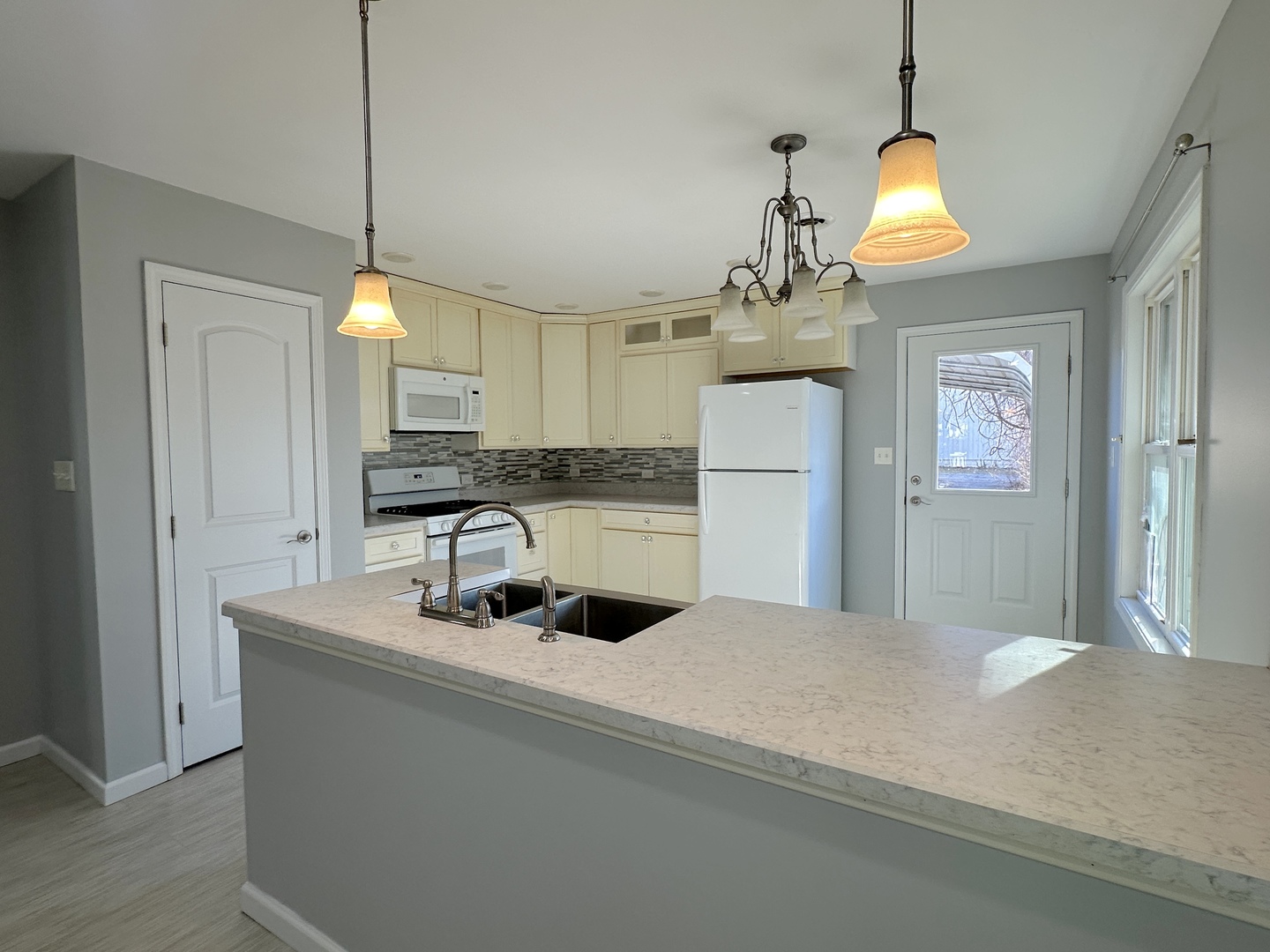 1519 Pine Street Murphysboro, IL 62966 - Photo 3 of 12 a kitchen with stainless steel appliances kitchen island granite countertop a sink a stove and refrigerator