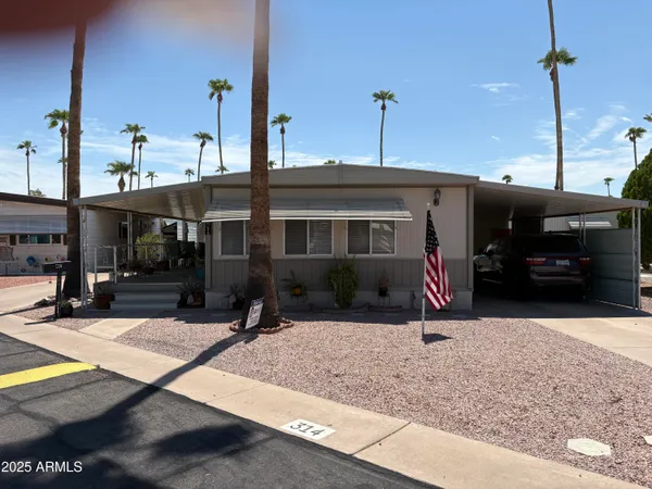 a view of a house with cars park
