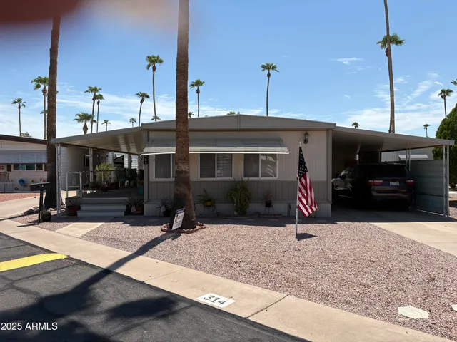 a view of a house with cars park