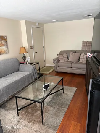 a living room with furniture and a rug