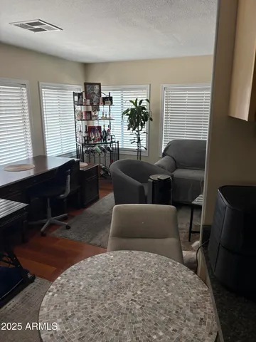 a living room with furniture a bookshelf and a window