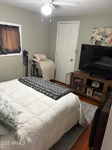 a bedroom with a bed and flat screen tv