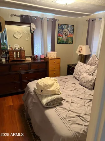 a bedroom with a bed and a mirror