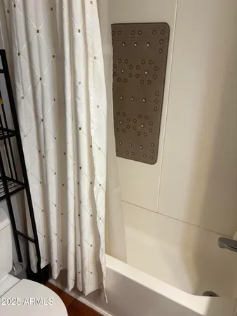 a bathroom with a bathtub and shower