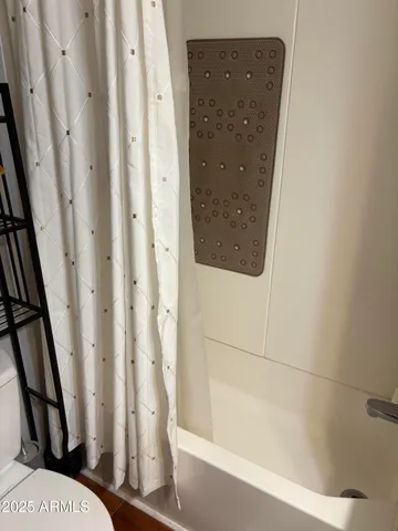 a bathroom with a bathtub and shower