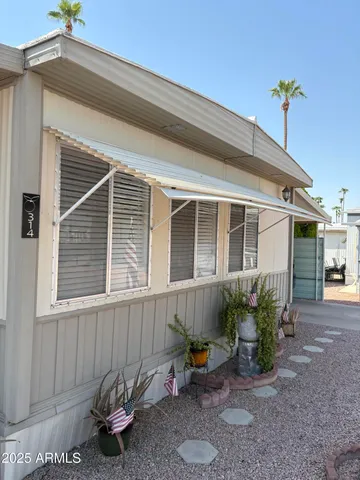 a front view of a house with table and chairs