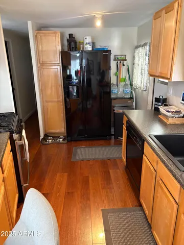 a view of a kitchen with refrigerator and sink