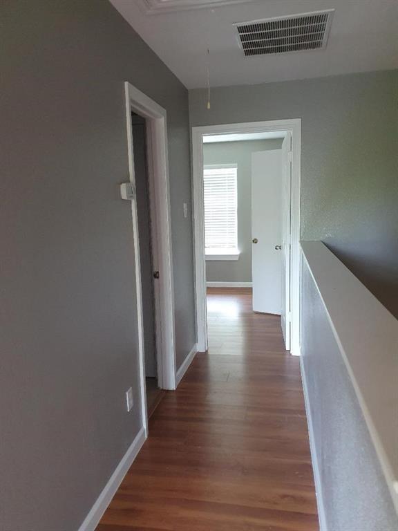 9821-9823 Sycamore Street Little Elm, TX 75068 - Photo 4 of 7 a view of a hallway with wooden floor