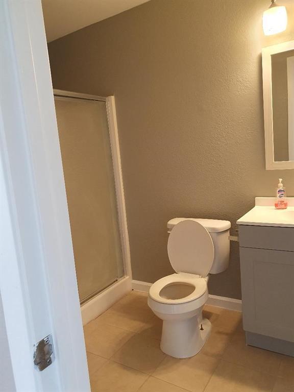 9821-9823 Sycamore Street Little Elm, TX 75068 - Photo 6 of 7 a white toilet sitting next to a small sink