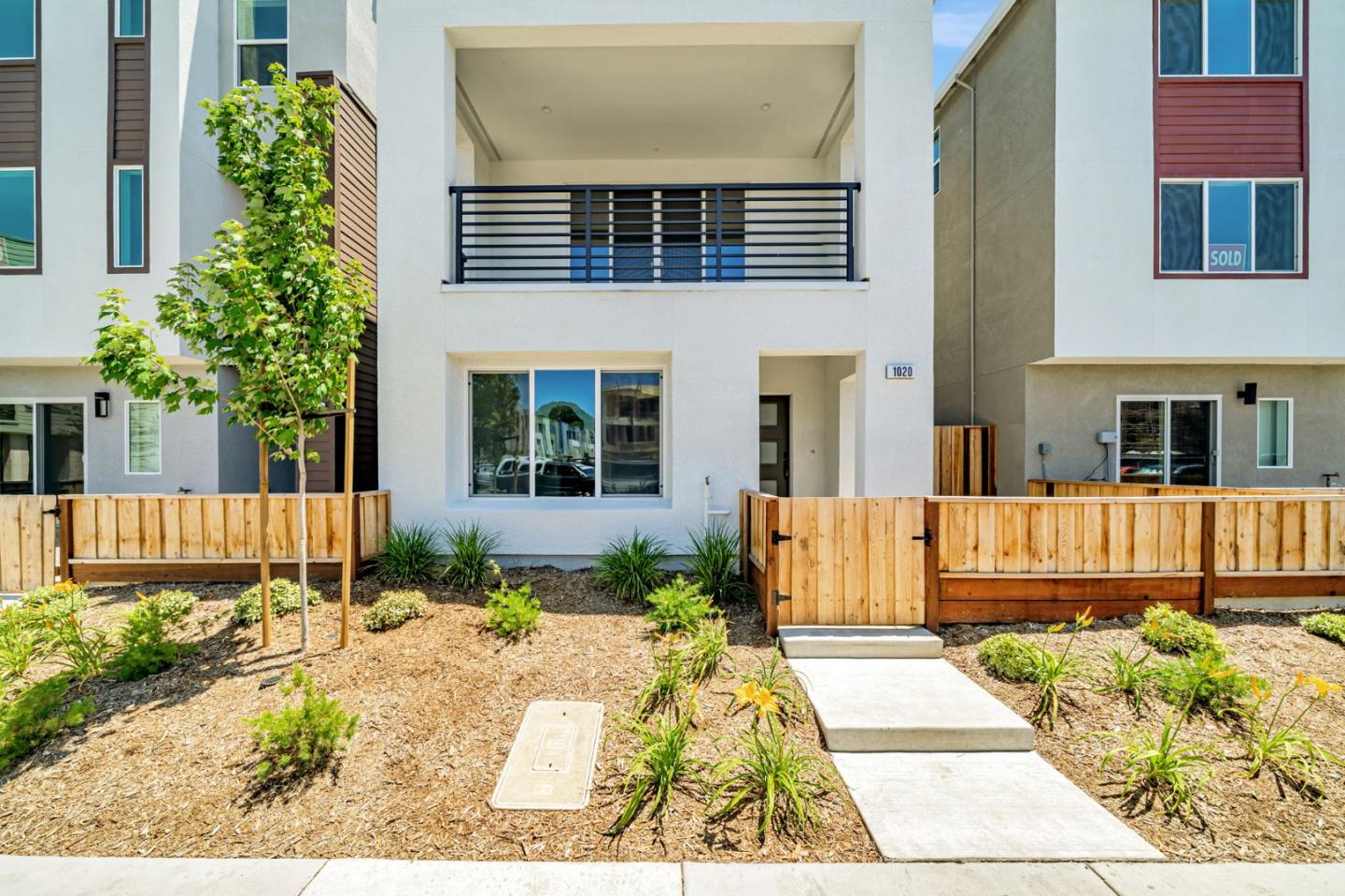 a view of a house with a small yard and plants