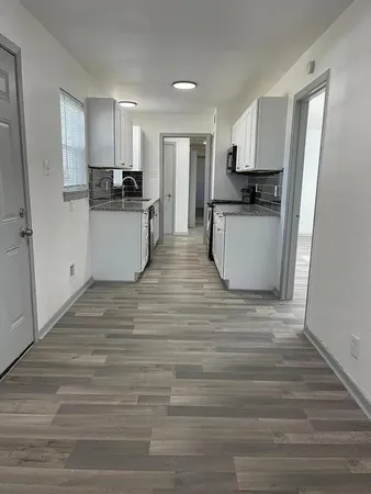 a view of kitchen with wooden floor