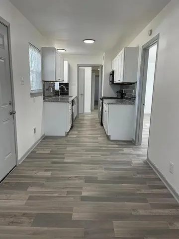 a view of kitchen with wooden floor