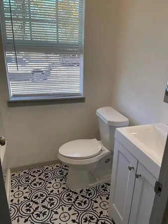 a bathroom with a toilet and a sink