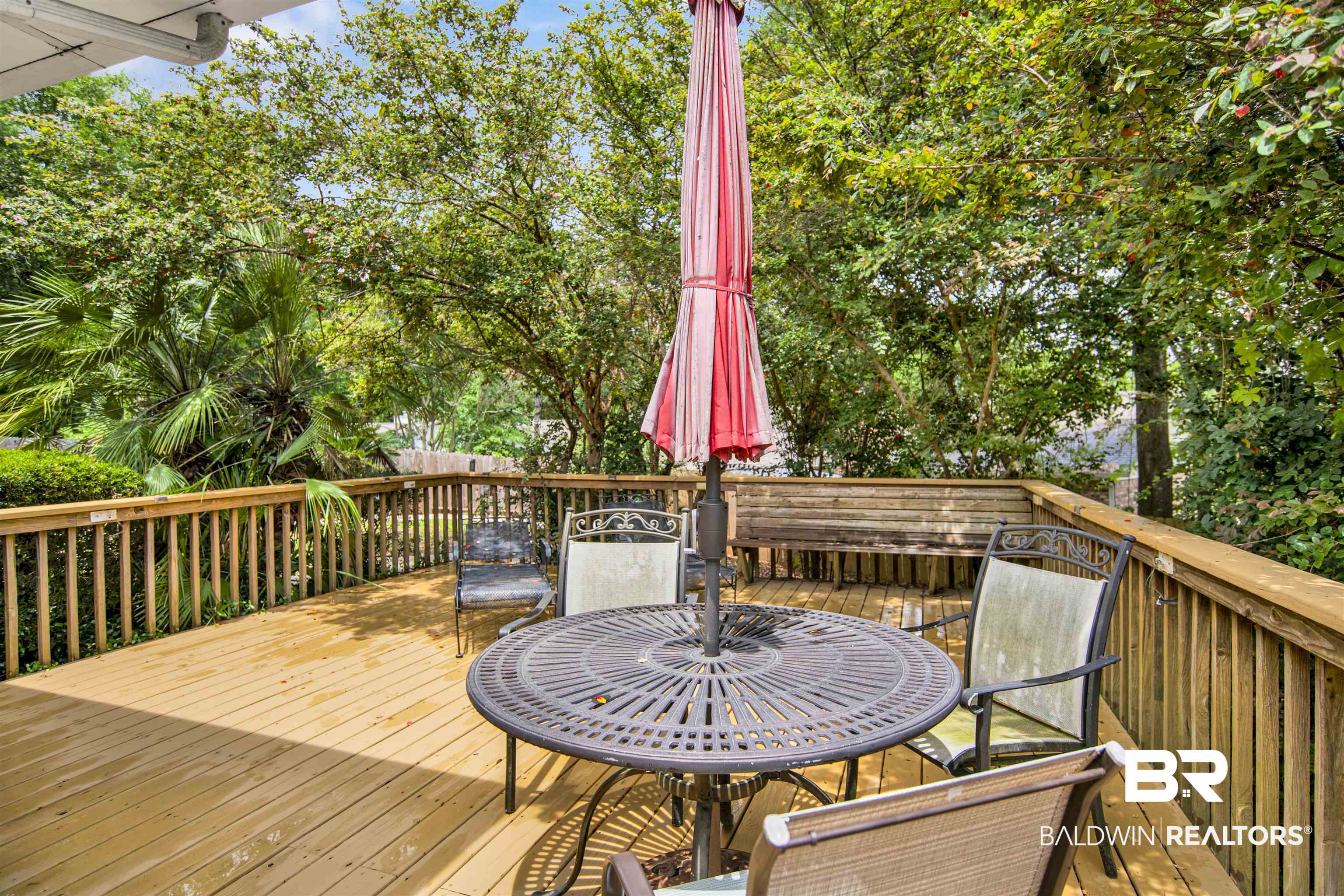 107 Virginia Circle Daphne, AL 36526 - Photo 34 of 47 Expansive wood deck with full railing and mature tree surroundings