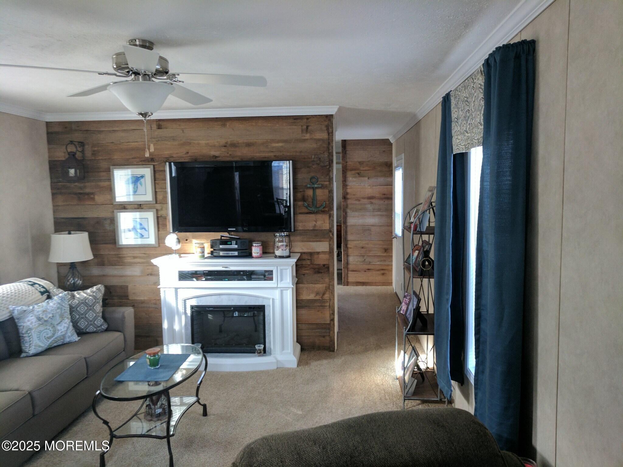 9 Shorehaven Road Hazlet, NJ 07730 - Photo 10 of 20 a living room with furniture a flat screen tv and a fireplace
