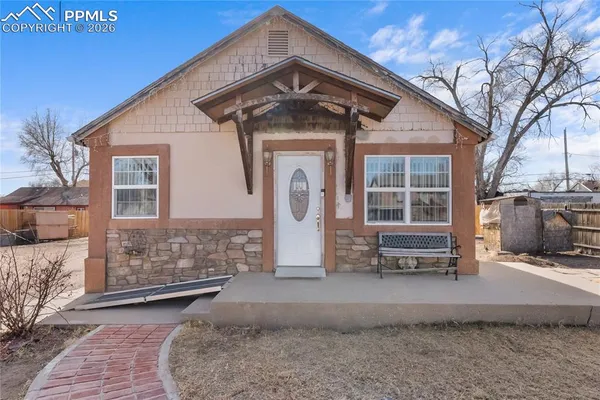 a front view of a house with parking area