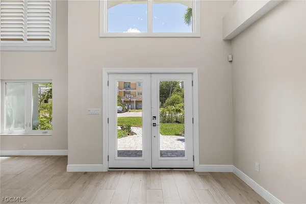 a view of an entryway with wooden floor and door