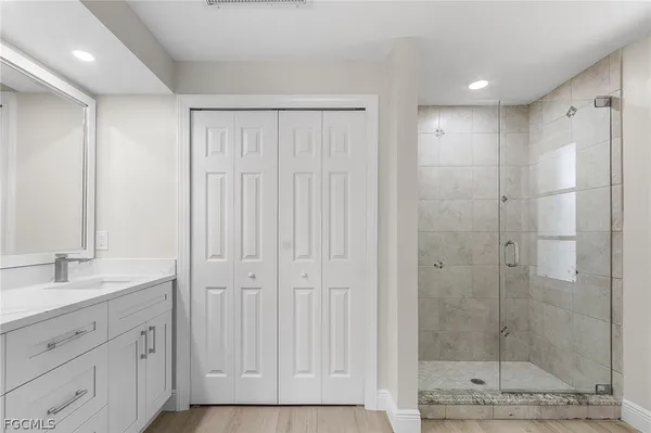 a bathroom with a shower and a sink