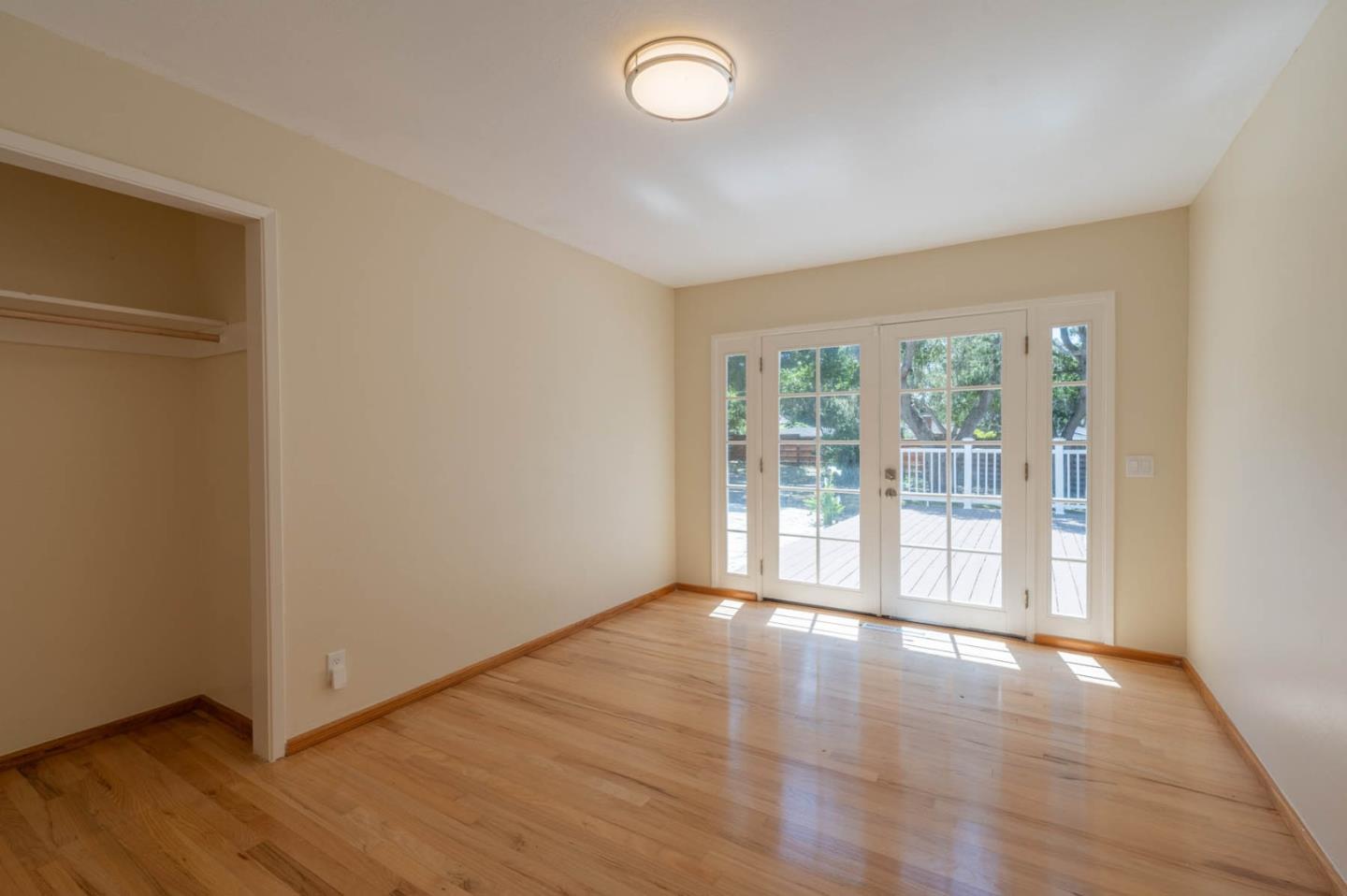 1044 Lost Barranca Road Pebble Beach, CA 93953 - Photo 13 of 15 a view of an empty room with wooden floor and a window