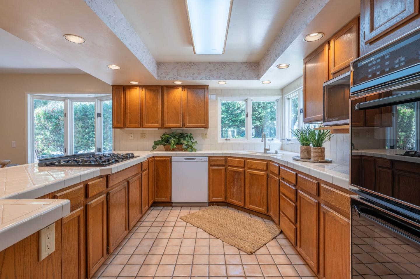 1044 Lost Barranca Road Pebble Beach, CA 93953 - Photo 6 of 15 a large kitchen with stainless steel appliances granite countertop sink stove and cabinets