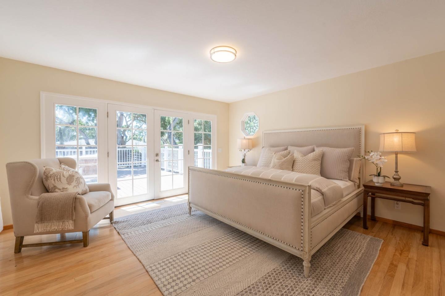 1044 Lost Barranca Road Pebble Beach, CA 93953 - Photo 7 of 15 a spacious bedroom with a bed and glass door