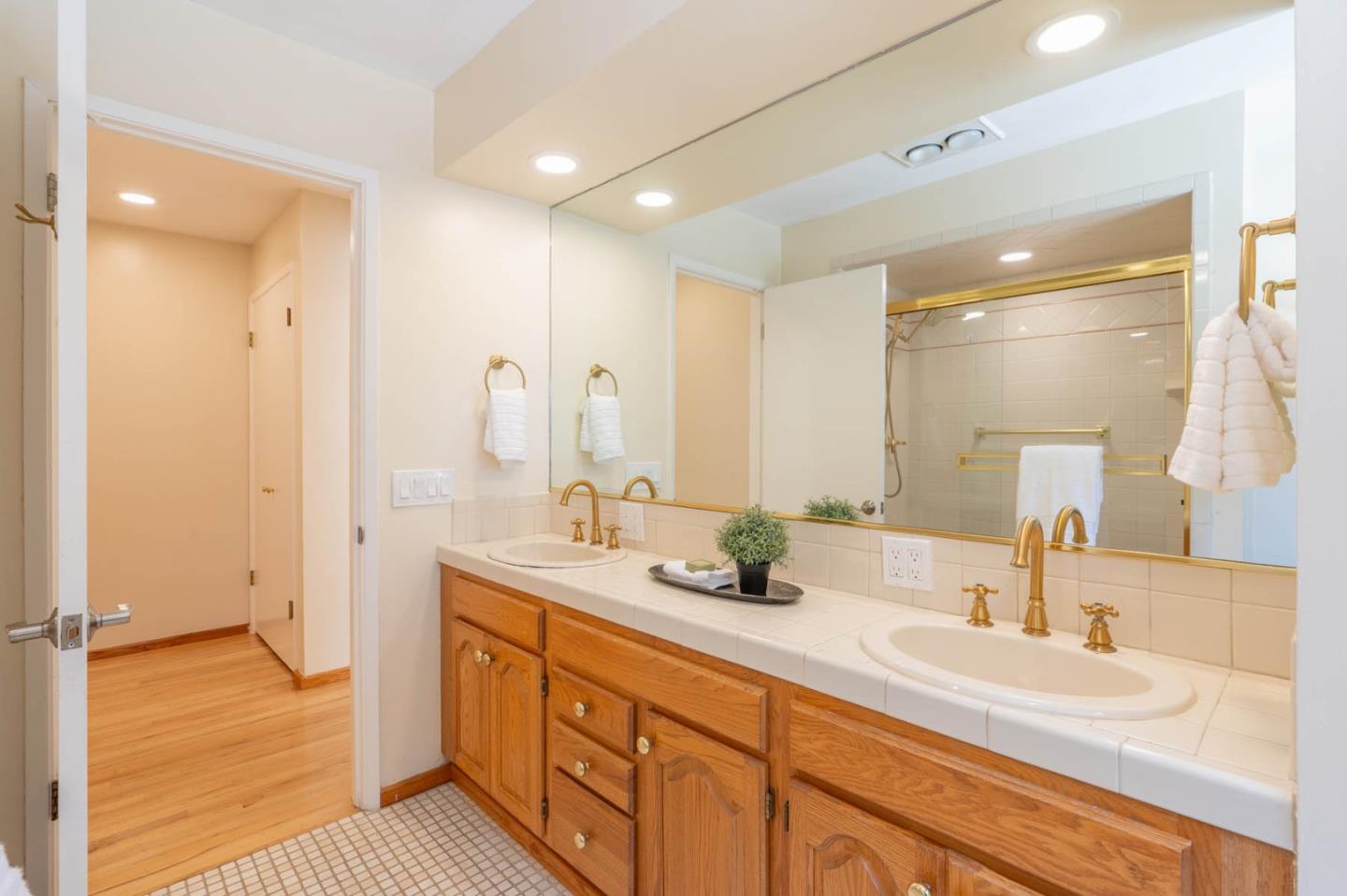 1044 Lost Barranca Road Pebble Beach, CA 93953 - Photo 9 of 15 a spacious bathroom with double vanity and a mirror